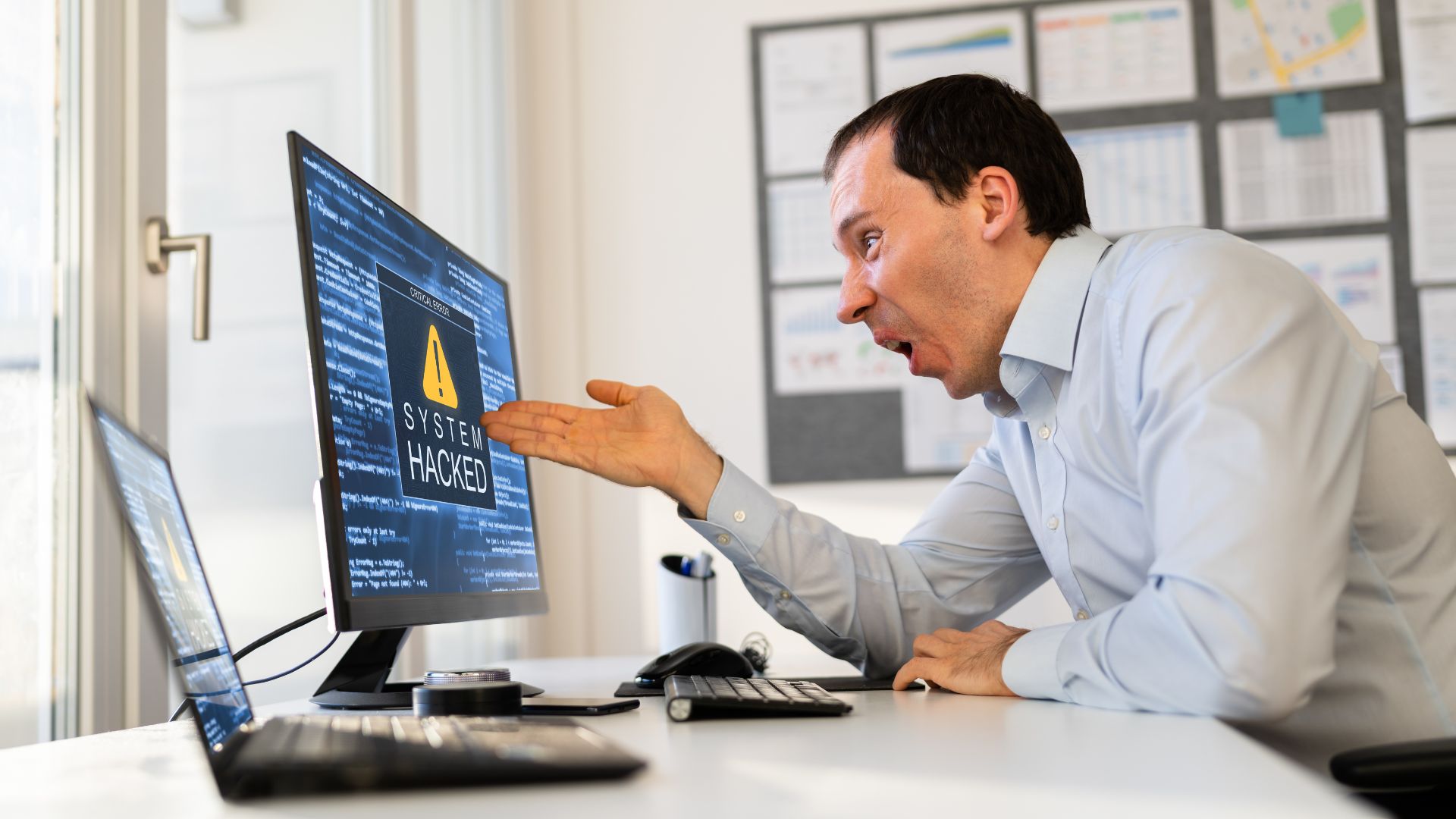 business person looking at computer screen after system was hacked