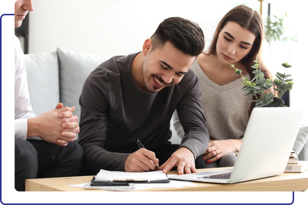 A homeowner signing an insurance agreement