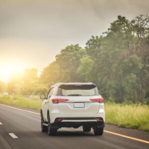 A white car driving on the highway