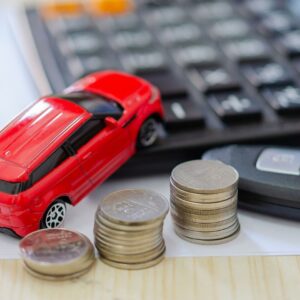 A car figurine with stacks of quarters